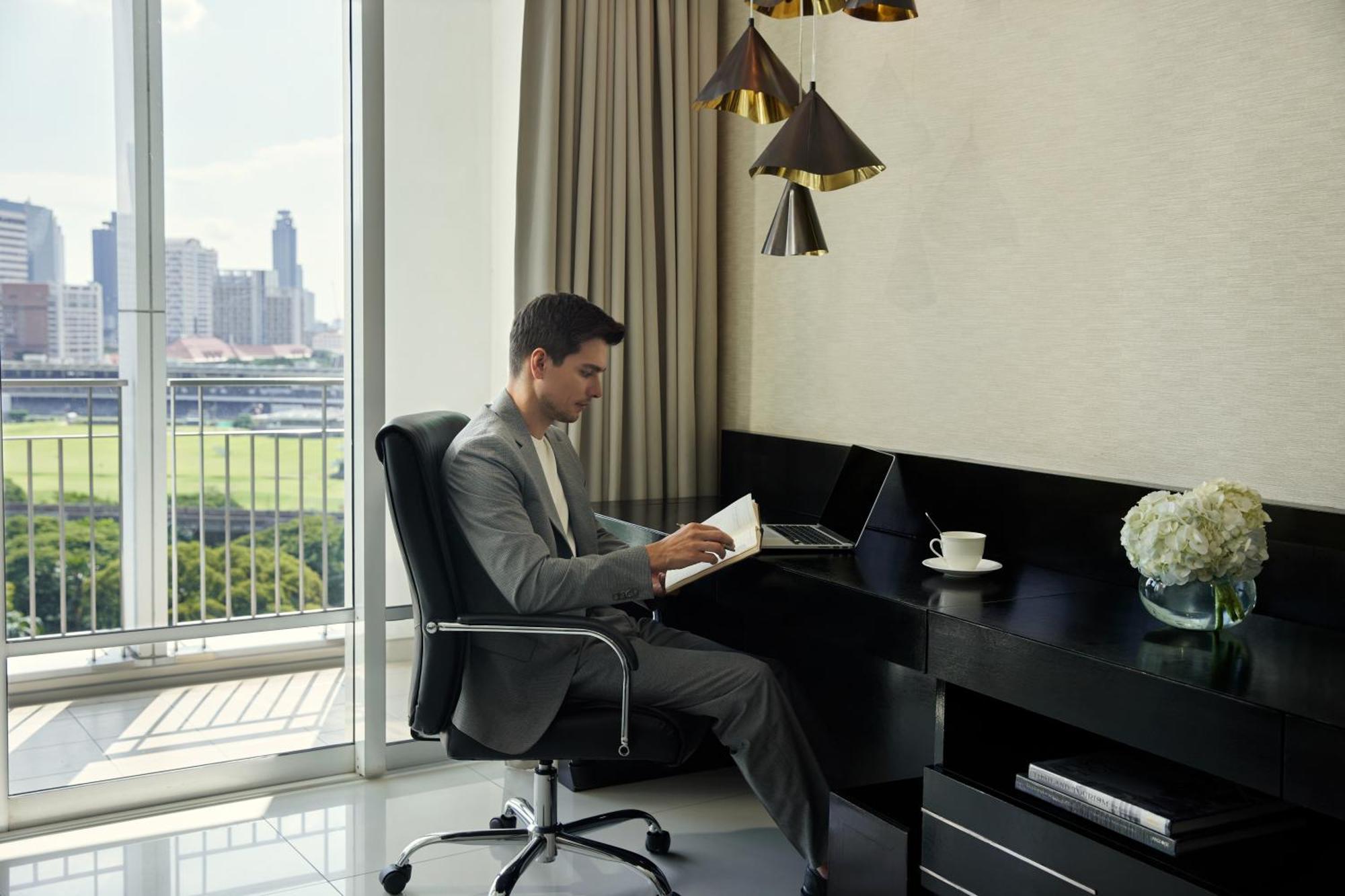 Dusit Suites Hotel Ratchadamri, Bangkok Extérieur photo A man working at a desk
